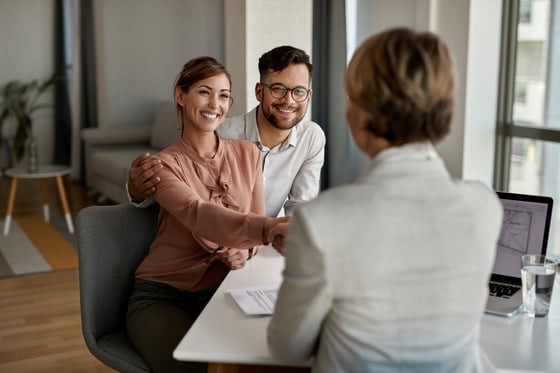 young-happy-couple-shaking-hands-with-insurance-agent-meeting-office